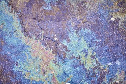 Unexpected rainbow colors shining in a muddy puddle. Unexpected rainbow colors in a muddy puddle!